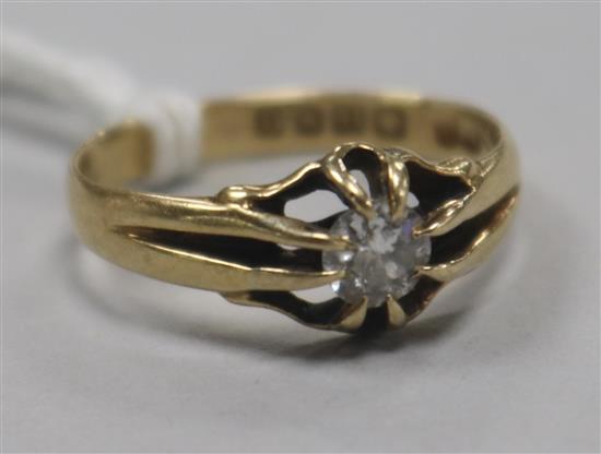 An early 20th century 18ct gold and claw set solitaire diamond ring, size O.